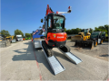 Digger going up alloy ramps 