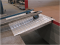 Pallet truck going up removable loading bridge 