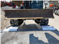 Ramps resting on flat bed trailer