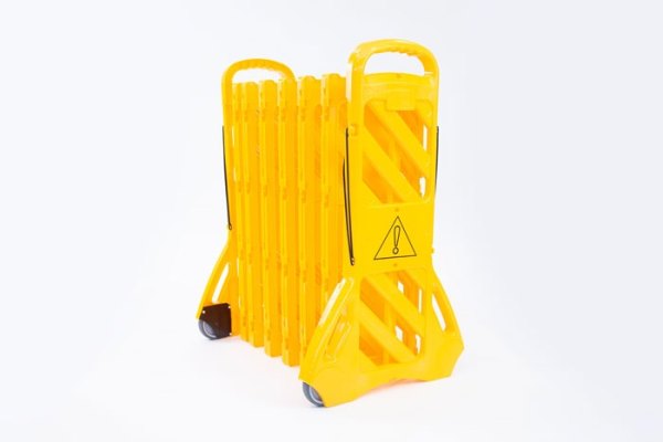 Yellow plastic expandable barrier on wheels 