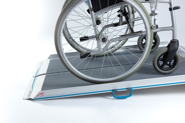 Manual wheelchair going up aerolight wheelchair ramp 