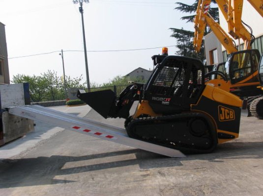 Loader driving on to loading ramps 