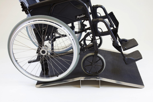 Wheelchair on bridge threshold ramp
