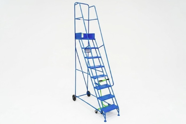 Narrow steel mobile warehouse ladder with 8 treads. Blue steel ladder with dual handrails and wheels.