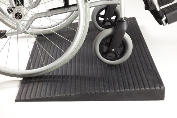 Wheelchair on rubber threshold ramp 