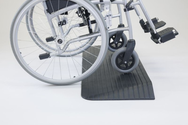 Wheelchair on rubber threshold ramp 