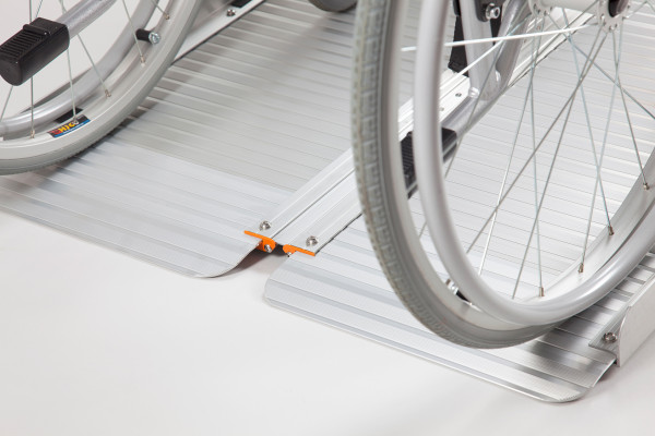 Manual wheelchair going up a portable wheelchair ramp