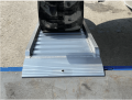 Rubber tracked digger on ramp 