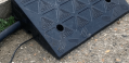 Black rubber kerb ramp fixing holes