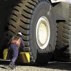 Person placing wheel chocks under wheel 