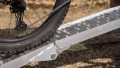 Motorbike loading ramp resting on vehicle boot with bike being loaded