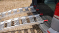 Pair of loading ramps resting on the vehicle 
