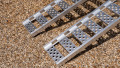 Pair of mtorcycle ramps resting on vehicle, close up of grip the foot end of the ramps