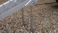 Single motorbike ramp with support legs resting on a vehicle , close up of the support legs