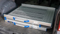 FEAL folding van ramp folded in the boot of a car showing the surface and handle