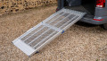 FEAL folding anyramp van ramp resting on boot of car