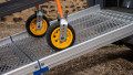 Close up of trolley wheels being pushed up during loading