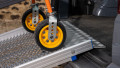 Close up of trolley wheels being pushed up during loading