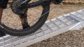 Folding extra wide motorcycle loading ramp resting on van