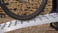 Folding extra wide motorcycle loading ramp resting on van