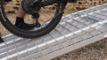 extra wide motorbike loading ramps resting on car with bike being loaded