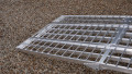 extra wide motorbike loading ramps resting on car, close up of foot end