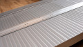 economy folding ramp resting on step, close up of surface showing the flat hinge 