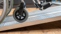 economy folding ramp resting on step with wheelchair being loaded