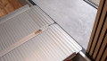 Extra wide folding wheelchair ramp resting on step, close up view of the rest on connection