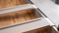 Close up of the rest on connections of low Profile Edge Channel Ramps resting on a step used for a wheelchair or mobility scooter