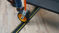 1 channel black and yellow cable protector with trolley going over the top of it