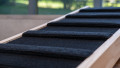 Close up of a wooden dog step showing the carpet surface