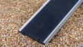 Telescopic dog ramp resting on the boot of a car, close up of the foot end