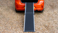 Telescopic dog ramp resting on the boot of a car