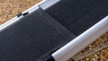 Telescopic dog ramp resting on the boot of a car, close up of the grip surface