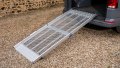 FEAL folding anyramp van ramp resting on boot of car