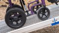 Manual wheelchair going up FEAL AnyRamp into a vehicle