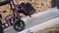Manual wheelchair going up FEAL AnyRamp into a vehicle
