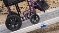 Manual wheelchair going up FEAL AnyRamp into a vehicle
