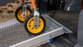 Close up of trolley wheels being pushed up during loading 