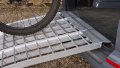 extra wide motorbike loading ramps resting on car with bike being loaded
