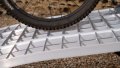 close up of the surface of an extra wide bike ramps kit resting on a vehicle 