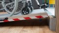 Extra wide wheelchair ramp resting on a step 