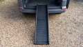 black folding pet ramp resting on the boot of a car