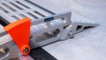 Close up of rest on connection on a step of a portable rollable aluminium wheelchair ramp