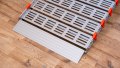 Close up of the foot end of a portable rollable aluminium wheelchair ramp
