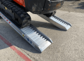 digger drivinh up ramp 