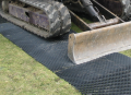 Vehicle driving over Trackguard mat on grass