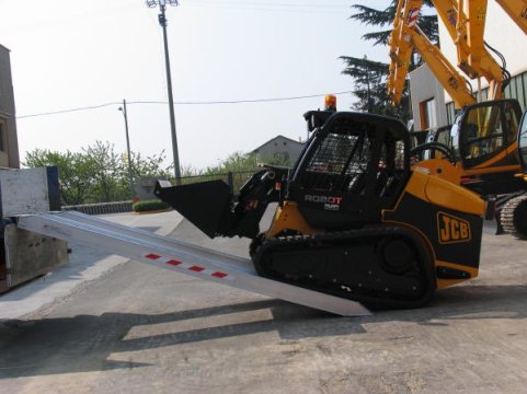Loader driving on to loading ramps 
