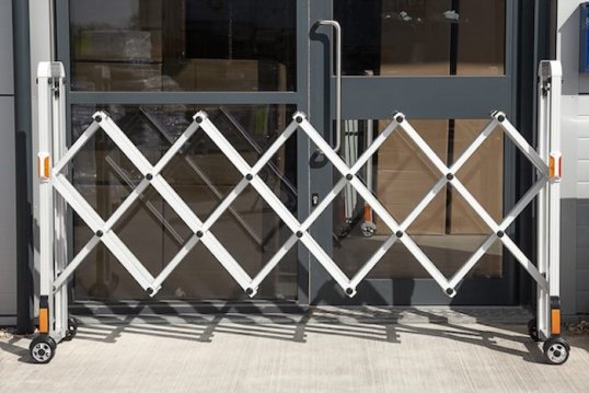 Expandable barrier outside front doors 